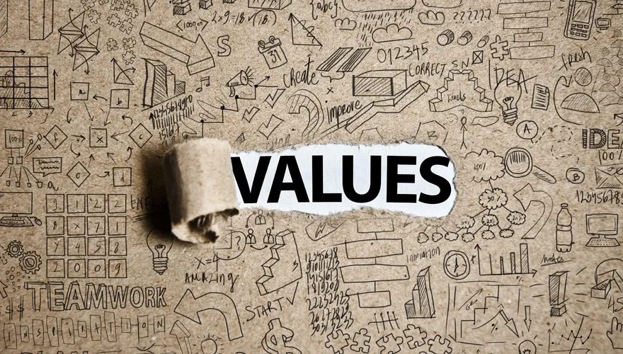 The word VALUES revealed on white paper through torn cardboard, surrounded by hand-drawn business doodles and icons