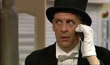 Man in a top hat and white gloves nervously dabbing his sweating forehead with a handkerchief
