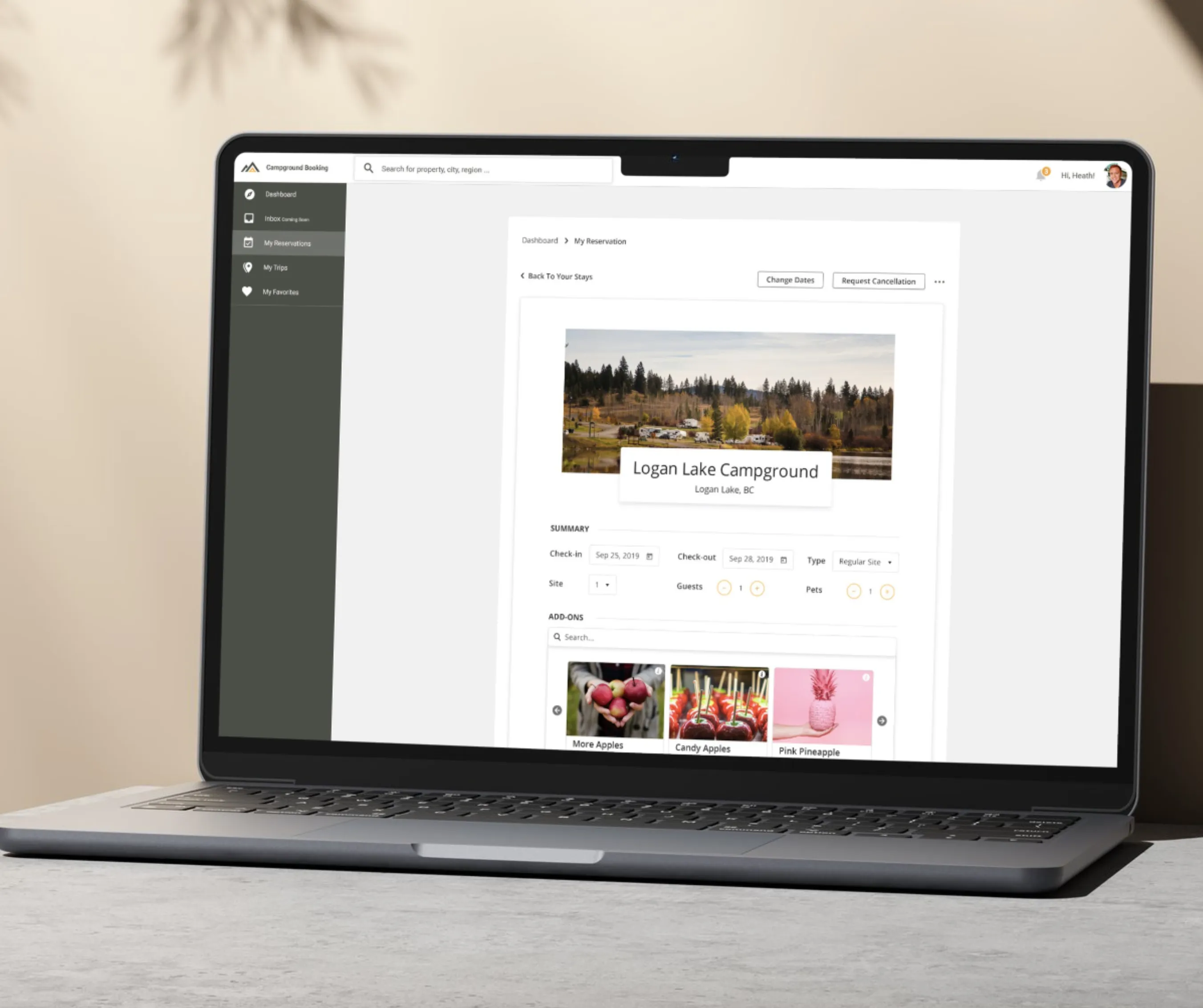 Laptop showing My Reservations screen for Logan Lake Campground with dates, guest details and add-on product thumbnails